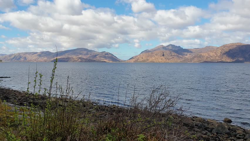 Scottish Loch Ness scenic view with calm placid water from shoreline amongst mountainous landscape in Scottish highlands, Scotland UK