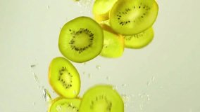 Fresh kiwi slices fall into water with splash effect, emphasizing freshness and motion. - Powered by Shutterstock - Get 15% off with code: PIKWIZARD15