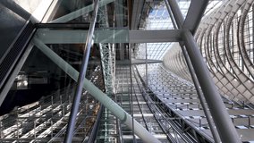 Low angle view of modern metal and glass walkway inside Tokyo International Forum, futuristic architecture and design. vertical video - Powered by Shutterstock - Get 15% off with code: PIKWIZARD15