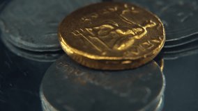 Macro Gold coin on a pile of Silver metal ancient coins, old drawings historical symbols, on a rotating stand, 4K smooth video - Powered by Shutterstock - Get 15% off with code: PIKWIZARD15