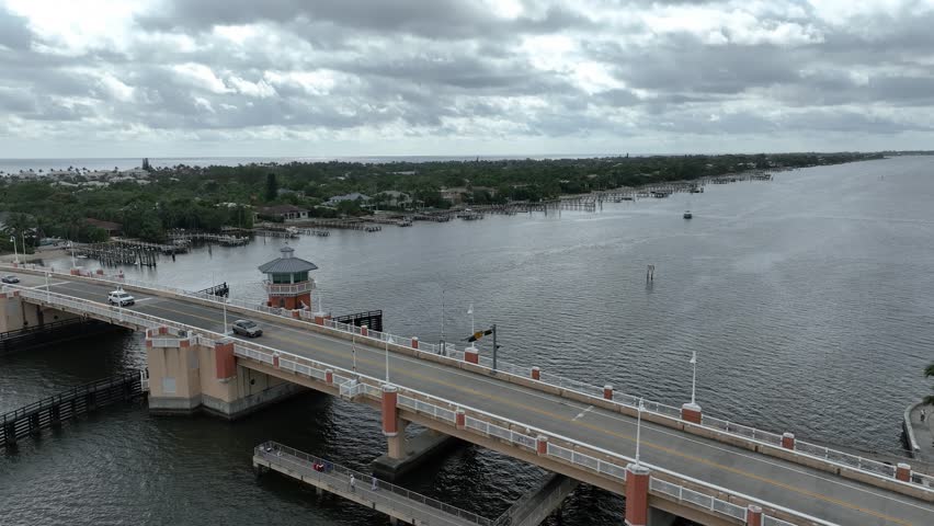Static drone shot of drawbridge over the Intracoastal Waterway in Lantana Florida showing traffic traversing the bridge