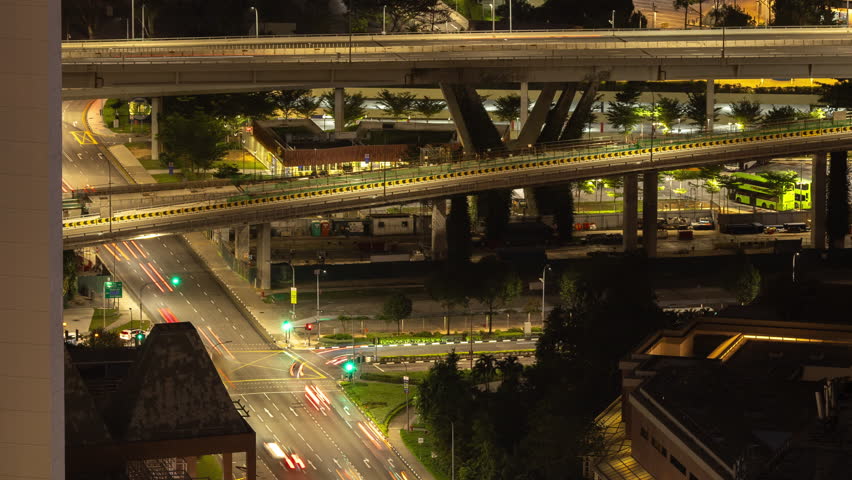 timelapse of the singapore city skyline and traffic on the roads at night