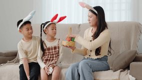Easter egg hunt fun. A mother and children with bunny ears hold a festive basket of Easter eggs, celebrating the joyful holiday together at home. family enjoys Easter - Powered by Shutterstock - Get 15% off with code: PIKWIZARD15