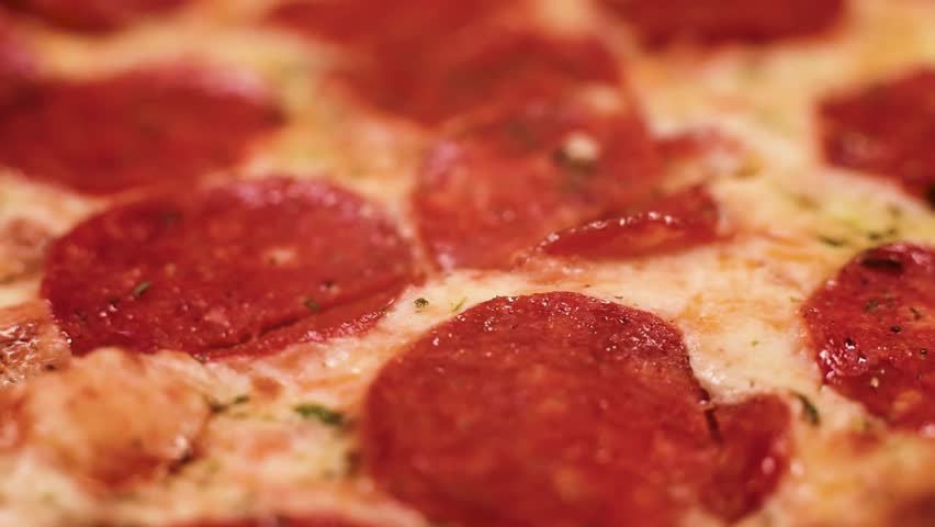 Pepperoni pizza close up spinning on table