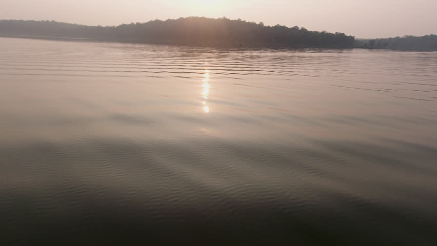 Evening boat safari on the tranquil Kabini River at dusk, serene and peaceful