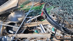 Stock of scrap metal dump on a waste disposal site for recycling. Selective waste sorting and civil environmental responsibility concept. 4K video, slow motion - Powered by Shutterstock - Get 15% off with code: PIKWIZARD15