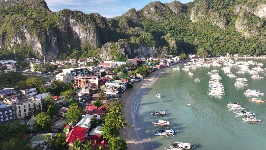 Tropical paradise of El Nido, Palawan. With majestic cliff and sandy beach. Bay with the boats.