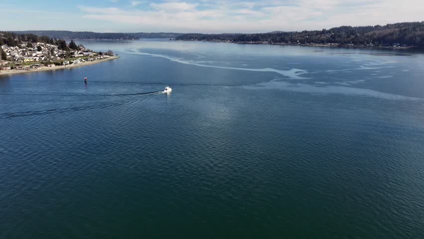 flying along Puget Sound with a long left panning across Manette community and Manette Bridge until Bremerton Marina and Ferry Terminal - 4k aerial video footage