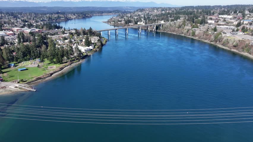 aerial video footage, backwards flying from "Warren Avenue Bridge" above Port Washington Narrows, with crossing of "Manette Bridge" the connection between Downtown Bremerton and community of Manette