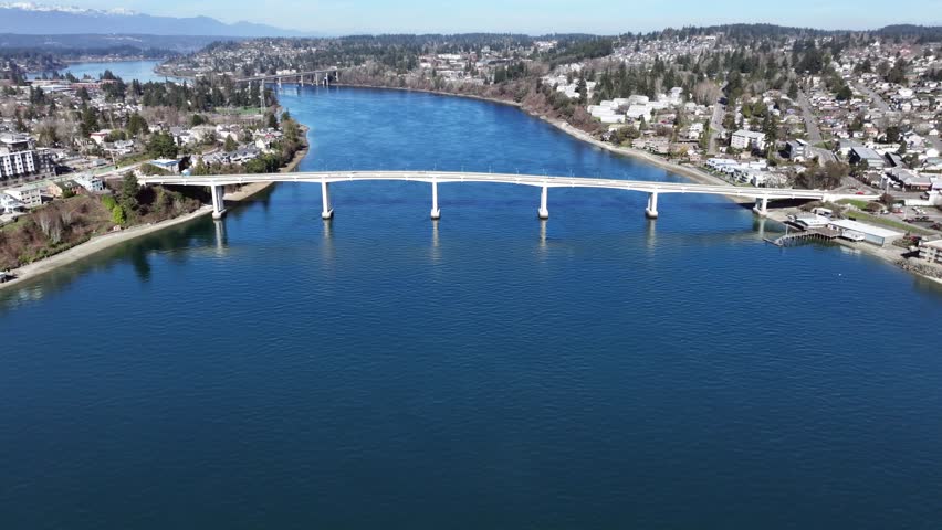 4k, aerial video footage, forward flying to "Warren Avenue Bridge" above Port Washington Narrows, with crossing of "Manette Bridge" the connection between Downtown Bremerton and community of Manette