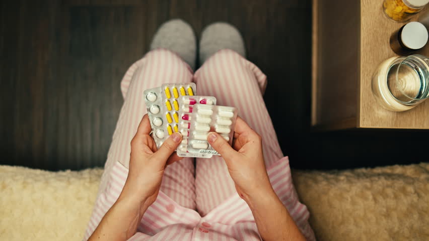Pills and vitamins macro, Close up view of womans hands holding plenty of different drugs. Painkillers and antibiotics. Healthcare and medicine concept