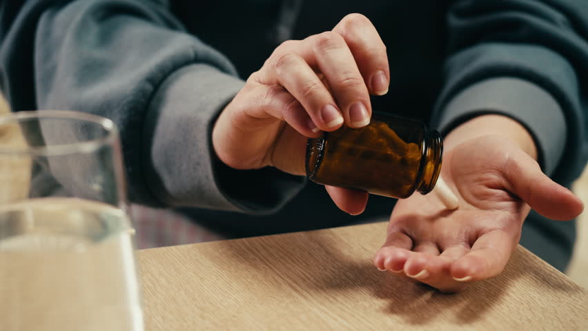 Pills and vitamins macro, Close up view of womans hands holding plenty of different drugs. Painkillers and antibiotics. Healthcare and medicine concept