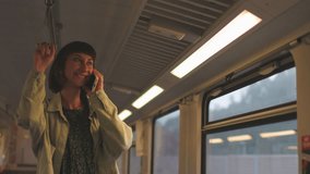 Girl talking on mobile phone in public transport in evening. Happy attractive woman using public transport during her daily commute to work. girl talking on smartphone. - Powered by Shutterstock - Get 15% off with code: PIKWIZARD15