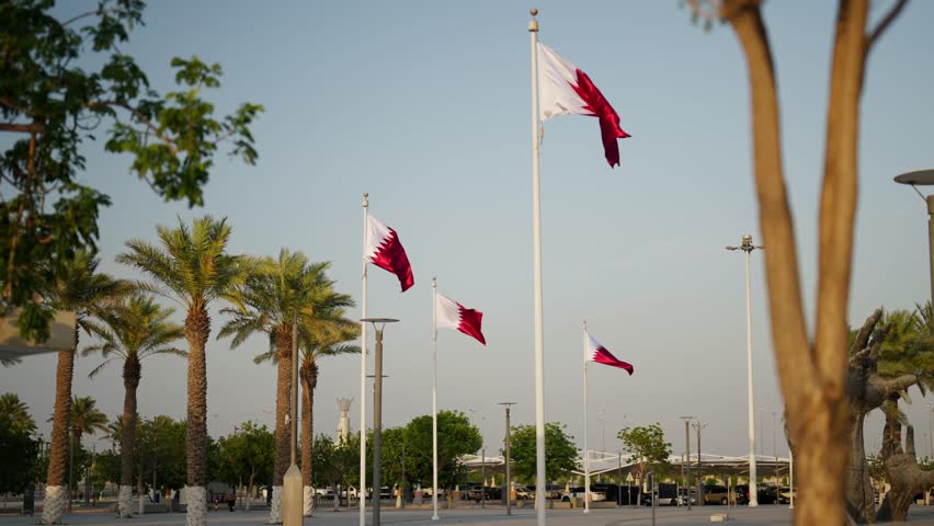 Slowmotion of qatar flags infront of stadium Lusail Multipurpose Hall