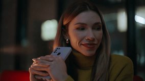 Woman messaging smartphone at dark apartment closeup. Portrait smiling business lady texting mobile phone in night office. Relaxed female blonde enjoy online communication by cellphone late evening. - Powered by Shutterstock - Get 15% off with code: PIKWIZARD15
