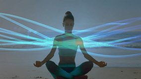 Meditating on beach, person surrounded by swirling blue light trails animation. Meditation, tranquility, mindfulness, serenity, relaxation, spirituality - Powered by Shutterstock - Get 15% off with code: PIKWIZARD15