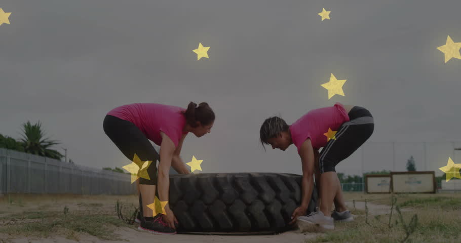 Lifting large tire, two people exercising with star animation overlay. Fitness, exercise, teamwork, strength, workout, gym