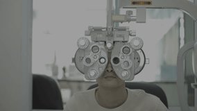 Professional scientist in protective equipment using Phoropter eye examination machine in patient treatment laboratory, eye treatment, vision care, eye measurement, science and medical concept - Powered by Shutterstock - Get 15% off with code: PIKWIZARD15