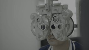 Professional scientist in protective equipment using Phoropter eye examination machine in patient treatment laboratory, eye treatment, vision care, eye measurement, science and medical concept - Powered by Shutterstock - Get 15% off with code: PIKWIZARD15