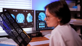 The doctor analyzing a patient's MRI scan to diagnose brain conditions and to plan treatment and the medication - Powered by Shutterstock - Get 15% off with code: PIKWIZARD15