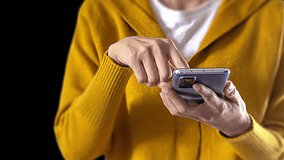 Close up to the hands. A woman's yellow hologram smart phone authenticates her fingerprint. - Powered by Shutterstock - Get 15% off with code: PIKWIZARD15