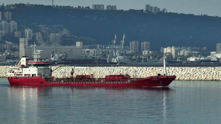 Oil tanker ship leaving a commercial port, Aerial view