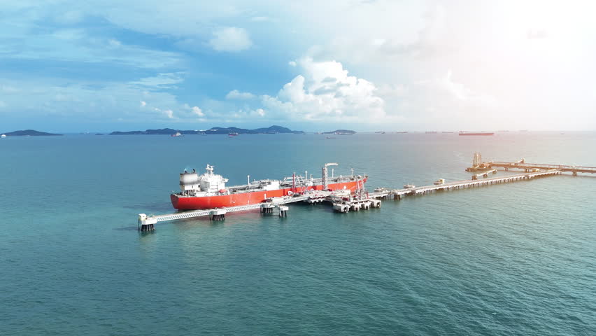 LPG ship, Oil tanker ship. Red Oil Tanker ranchored in Gas terminal gas tanks for storage. petroleum ship transportation import export fuel energy across red ocean sea. Vessel transport Gas 