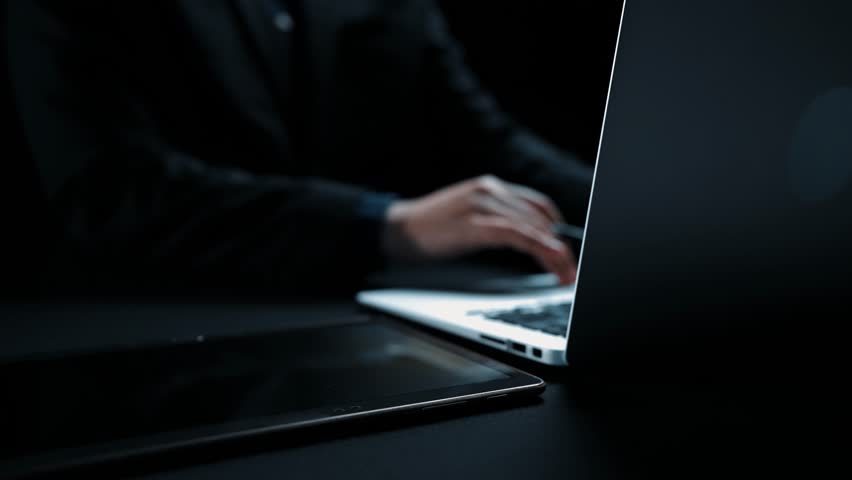 A modern business communication concept showcasing a hand reaching for a digital interface displaying contact options on a dark office background. Qubit