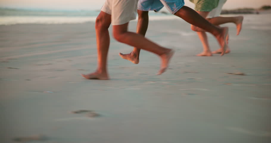 Beach, energy and feet of friends running on sand together for bonding, holiday or vacation closeup. Adventure, excited and travel with group of people outdoor on coast at ocean or sea for getaway