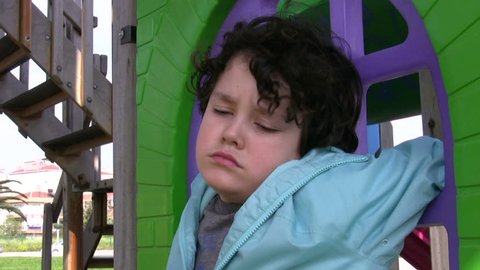 Sad boy crying in the playground