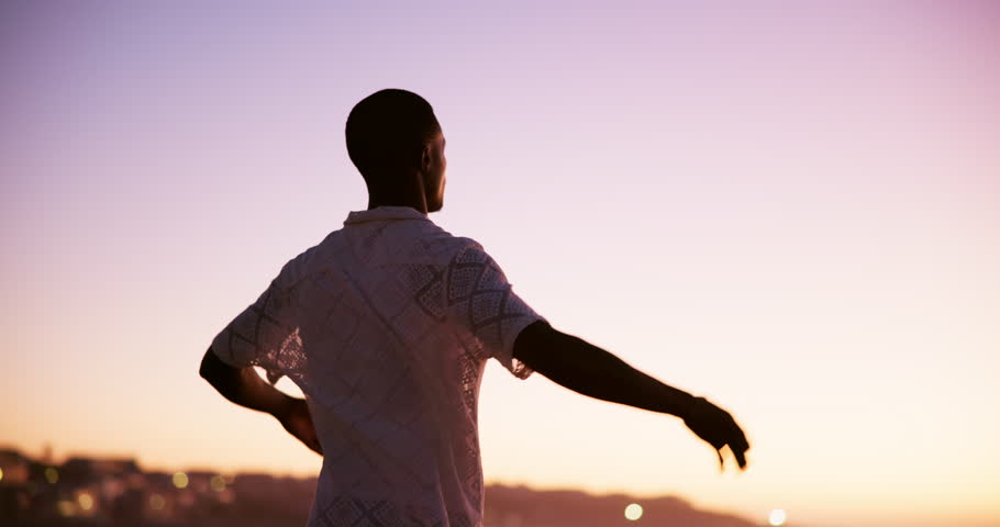 Back, man and sunset with freedom outdoor for summer vacation, travel and celebration. Male person, arms spread and holiday adventure, calm morning and weekend break with getaway achievement of trip