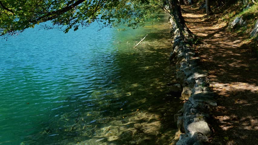 A peaceful lake reflecting the summer sky. A misty waterfall creating a tranquil atmosphere. A tranquil lake surrounded by mountains in Croatia. A peaceful summer view of Plitvice Lakes. - Powered by Shutterstock - Get 15% off with code: PIKWIZARD15
