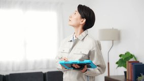 A female worker inspecting a room while looking at a tablet - Powered by Shutterstock - Get 15% off with code: PIKWIZARD15
