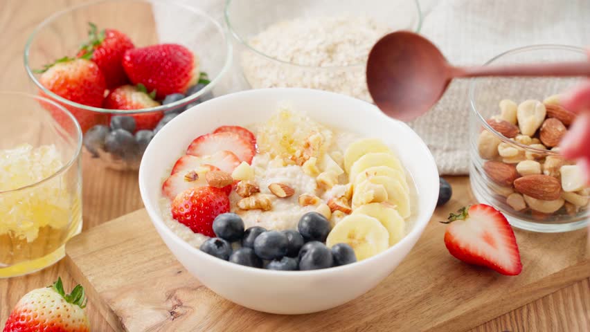 Healthy Oatmeal Breakfast – Topped with Fruits, Nuts, and Comb Honey