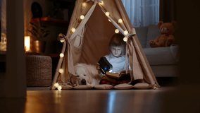 Peaceful Bonding: A Child in Pajamas Reads a Story While His Adorable Golden Retriever Restfully Lays Beside Him.Golden retriever and child reading book in cozy tent - Powered by Shutterstock - Get 15% off with code: PIKWIZARD15