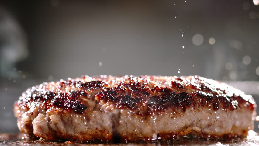 Fried vegetarian cutlets made from vegetable protein. Cinematic advertising plant-based imitation burger cooking. Pan-fried vegetarian cutlets delicious and healthy alternative to meat. Soy protein