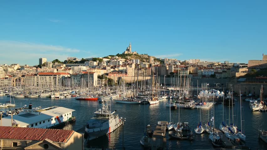 Marseille city skyline on a sunny day, France. Beautiful view of Vieux Port and Basilique Notre-Dame de la Garde on the French Riviera. Still shot