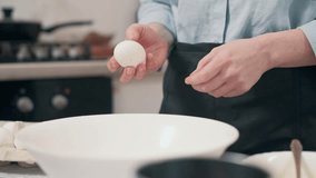 Woman preparing food. Female breaking egg into glass bowl at home in kitchen. Close-up of hands. - Powered by Shutterstock - Get 15% off with code: PIKWIZARD15