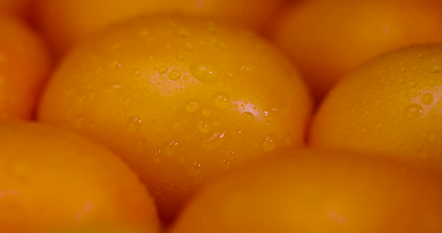 tomatoes that are on the table, whole clean washed orange tomatoes with dense and juicy flesh