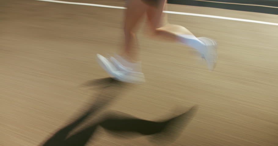 Running, fitness and motion blur of legs of person in city for workout, marathon training and exercise. Sports, fast and athlete on street with speed for challenge, endurance and performance for race
