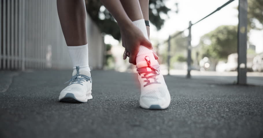 Athlete, hands and ankle pain on street with injury, fatigue and sprain with inflammation in city. Person, runner and overlay for fitness, workout and exercise with joint ache and stress on sidewalk