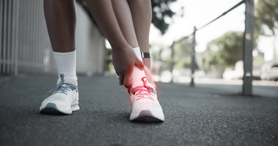 Athlete, hands and ankle pain on street with injury, fatigue and sprain with inflammation in city. Person, runner and overlay for fitness, workout and exercise with joint ache and stress on sidewalk