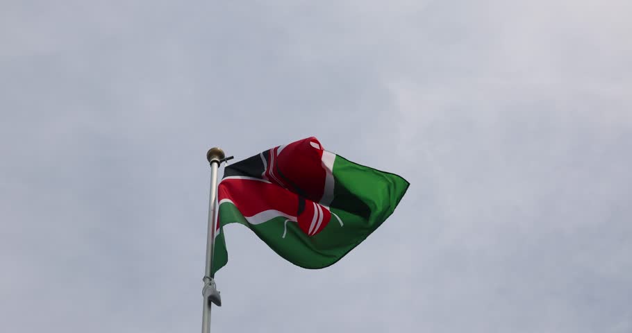 Kenya flag. National flag of Kenya fluttering in the wind. Great for news. Kenya flag against blue sky. 4K video.