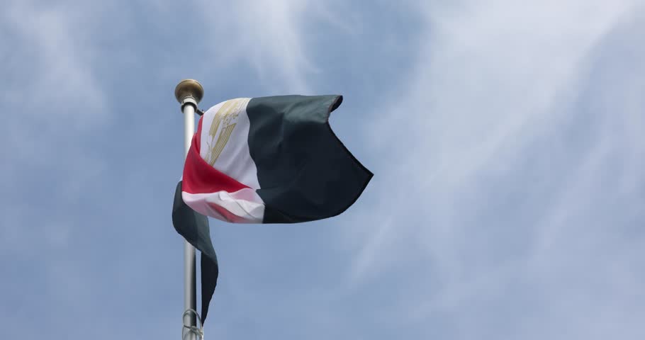 egypt flag. The national egypt flag fluttering in the wind. Great for news. egypt flag against a blue sky. 4K video.
