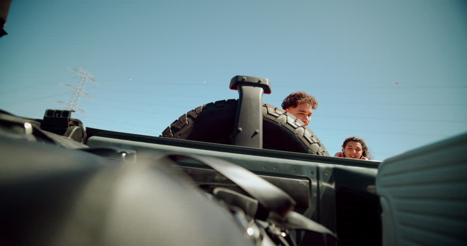 Couple, suitcase and trunk of car for road trip, travel or vacation preparation outdoor. Man, woman or loading luggage in vehicle, transport or truck bed for holiday adventure or journey in low angle
