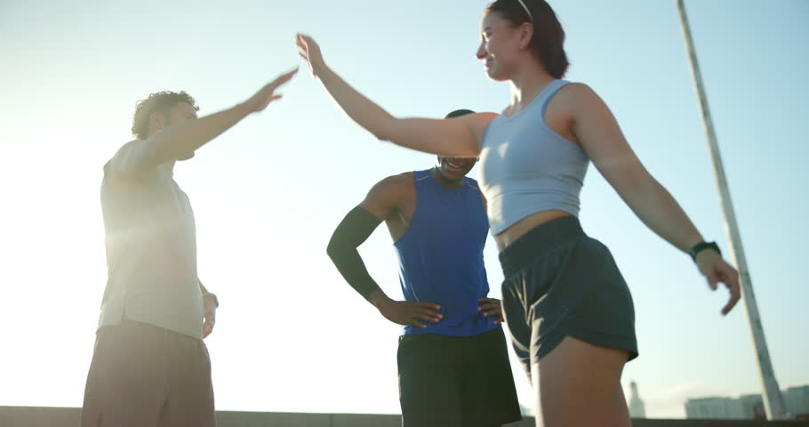 Athlete, people and high five for fitness in city of success, exercise support and team celebration. Below, friends and and running progress for sport break, cardio achievement and marathon practice