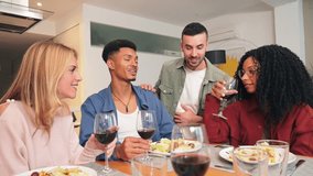 Joyful friends enjoying a delightful dinner together while sharing laughter and engaging in meaningful conversations with glasses of wine at a cozy home gathering creating memorable moments - Powered by Shutterstock - Get 15% off with code: PIKWIZARD15
