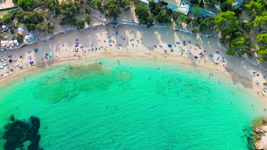 Ibiza Cala Bassa beach with turquoise water, aerial drone views