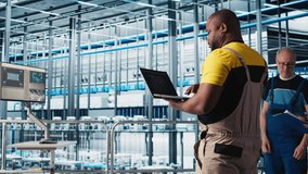 Photovoltaics smart factory expert designing production lines for assembly facility in CAD program. Industry 4.0 solar panels plant technician uses software to optimize floor layouts, camera A - Powered by Shutterstock - Get 15% off with code: PIKWIZARD15