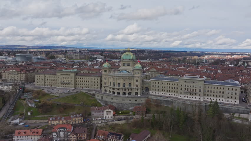 Aerial cityscape revealing Swiss governmental landmark, site of Swiss Federal Assembly and Federal Council nestled within historic Bern landscape